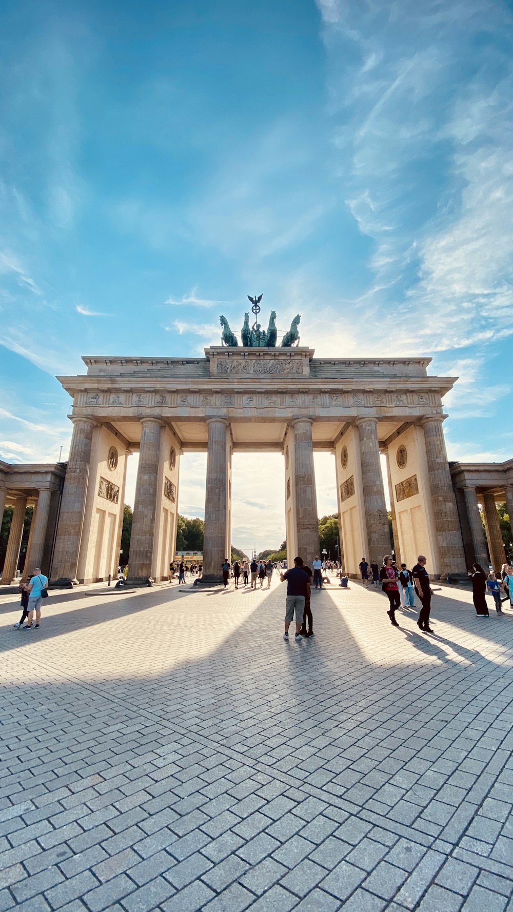 a large stone building with columns and statues on top