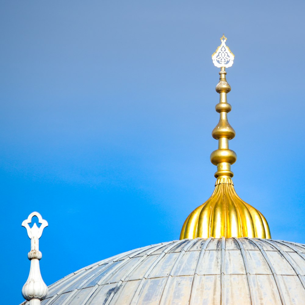 a gold domed roof with a gold top and a gold cross on top