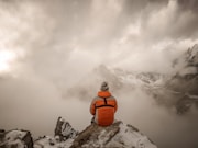 a snow covered mountain with clouds
