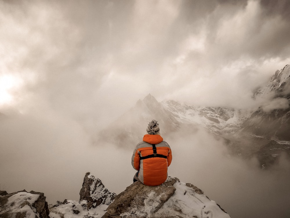 a snow covered mountain with clouds