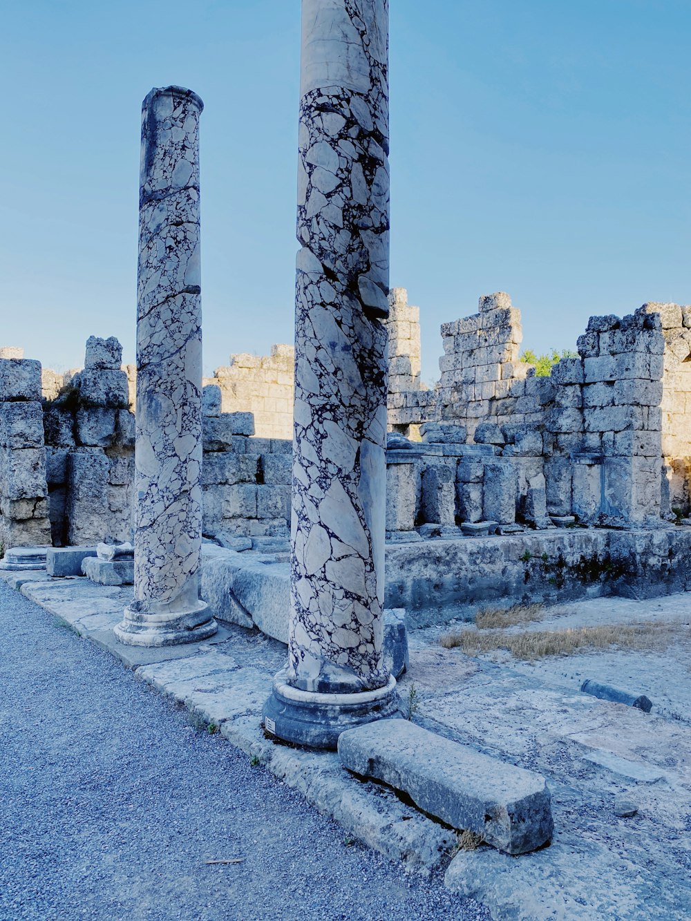 a stone structure with pillars in the snow