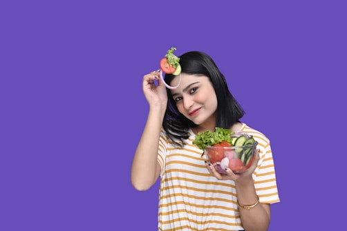 a person holding a bowl of fruit