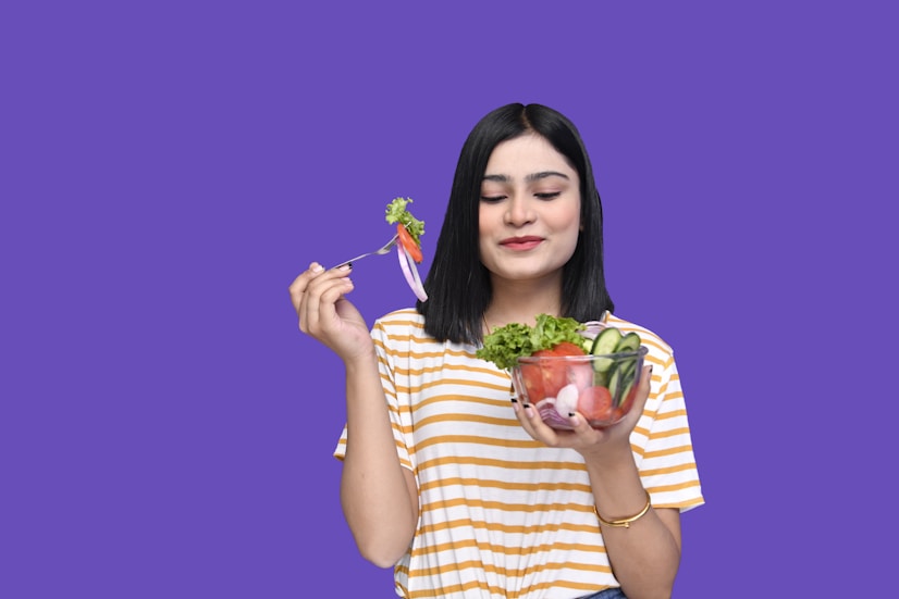 a woman holding a bowl of fruit