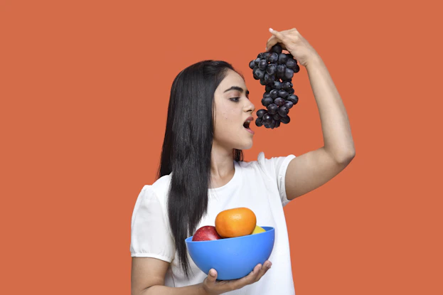 a person holding a bowl of fruit