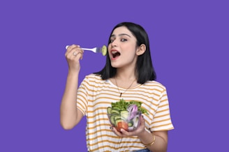 a person holding a bowl of fruit