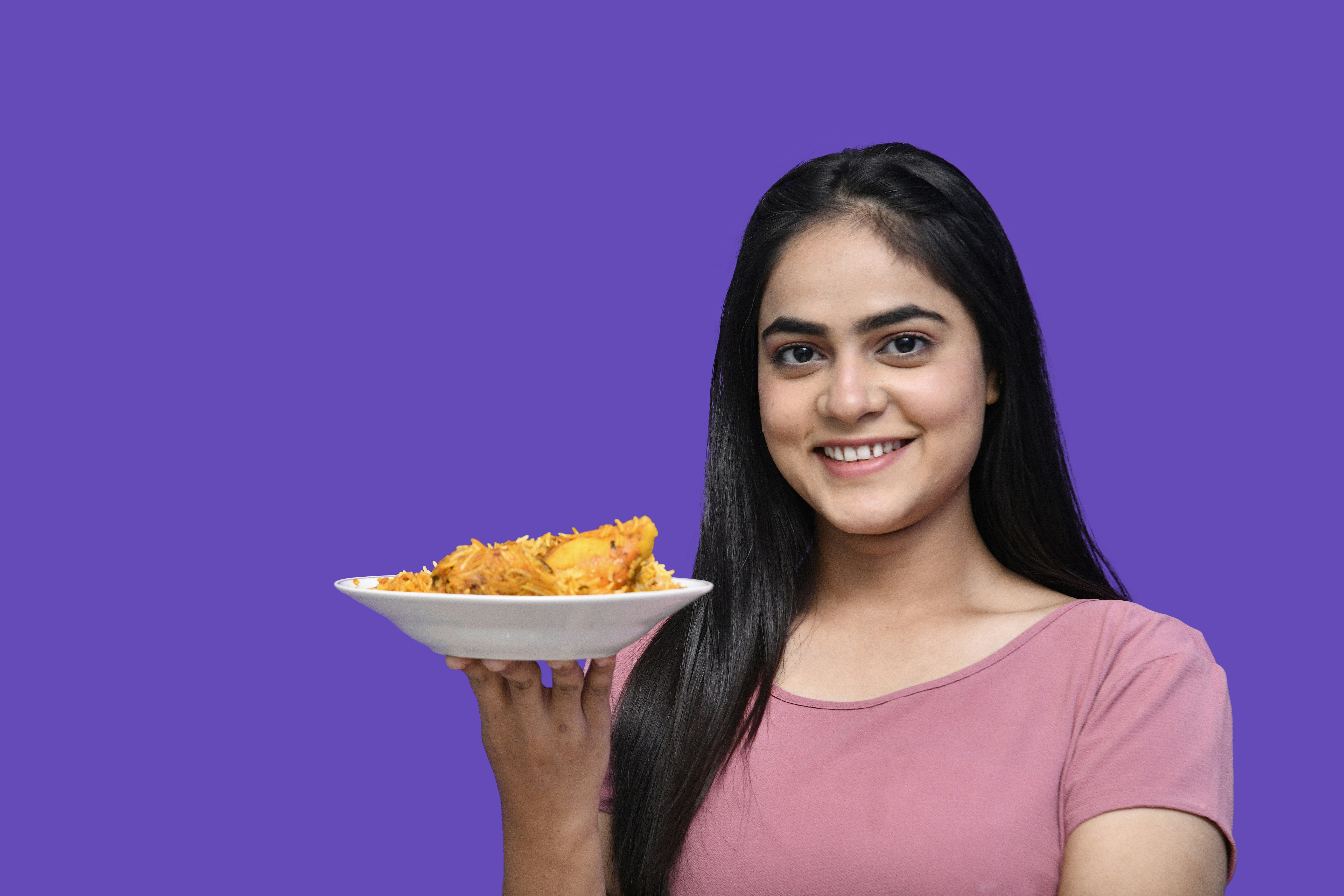 a woman holding a plate of food