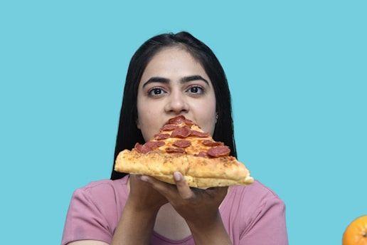 a woman eating a slice of pizza