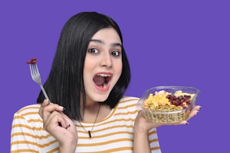 a woman holding a bowl of food