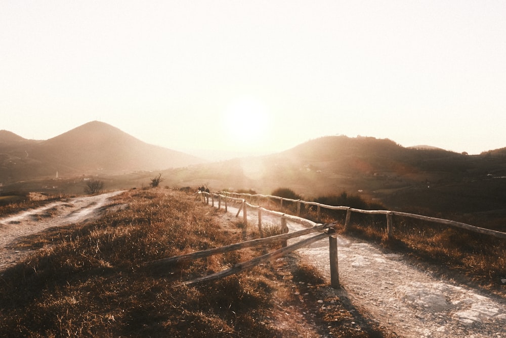 a fence on a dirt road