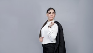A close-up of a confident actor posing against a simple white background.