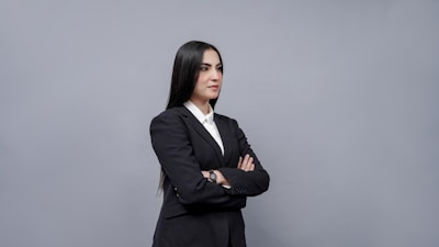 A professional portrait of a businesswoman smiling confidently against a clean white background.