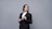 a person in a suit holding a clipboard