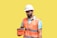 A male construction worker wearing a white hard hat and orange safety vest is holding an orange case. He is looking at the case, standing against a plain yellow background. The worker is also wearing a blue shirt under the vest.