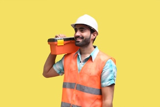 a person wearing a hard hat and holding a drill