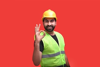 a person wearing a safety vest and holding up the hand