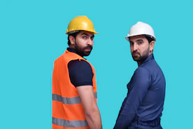 a couple of men wearing hard hats
