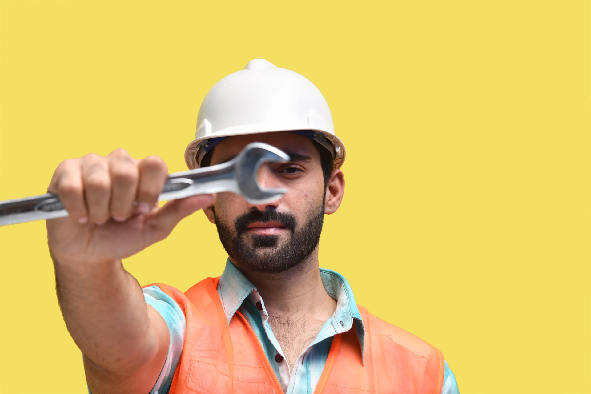 a man wearing a hard hat and holding a gun