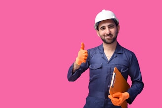 a person wearing a hard hat and holding a yellow object