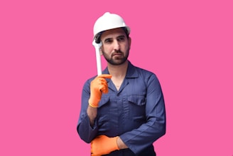 a person wearing a hard hat and holding a hammer