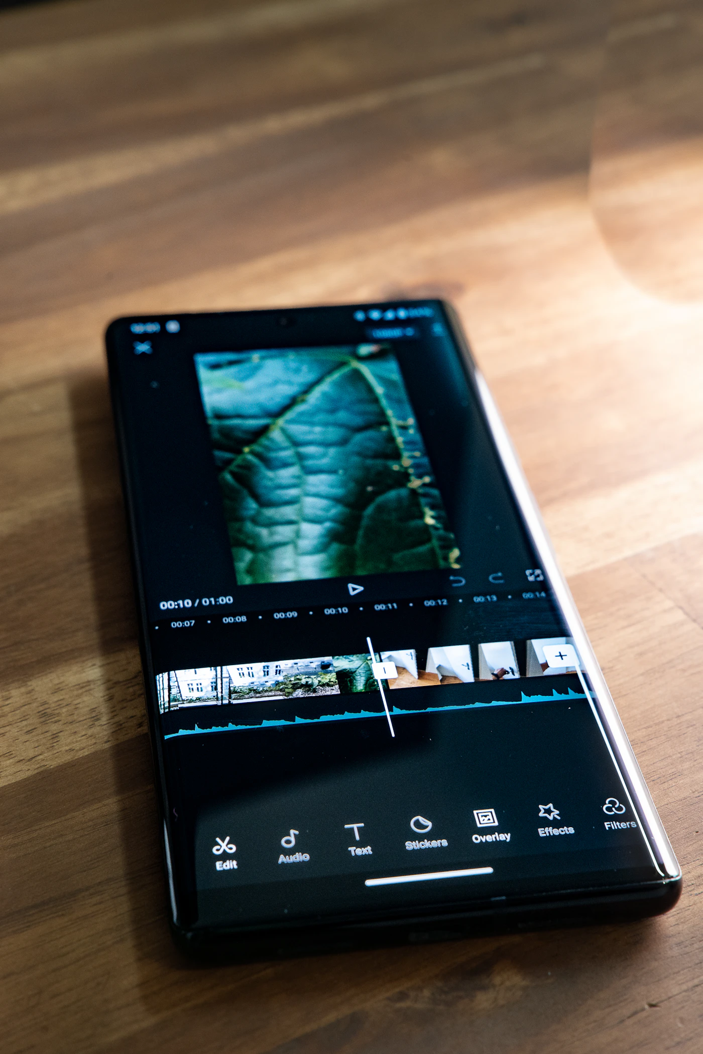 A smartphone displaying a mobile video editing timeline