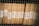 Stacks of organized brown files are secured behind a wire mesh. Each file is labeled with handwritten tags displaying the numbers 1956 and codes like 343 and 352. The scene reflects a methodical storage system, possibly for records or documents.