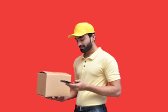 a man in a yellow hard hat holding a phone