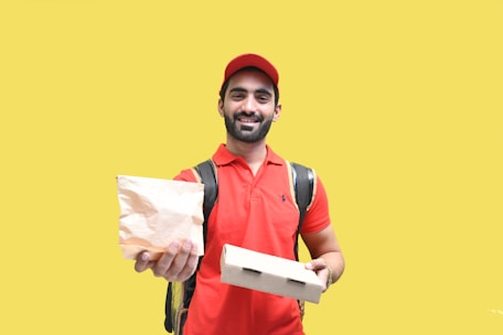 a man holding a bag and a paper