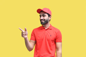 a man wearing a red hat and holding up his middle finger