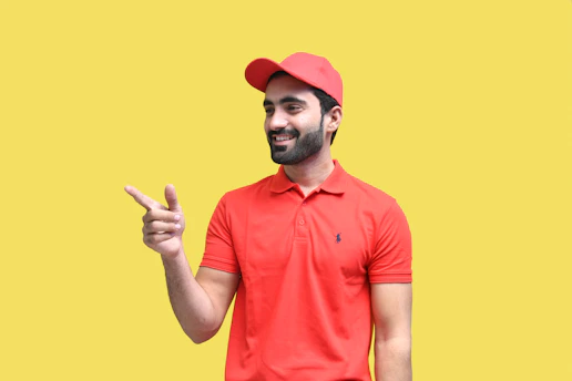 a man wearing a red hat and holding up his middle finger