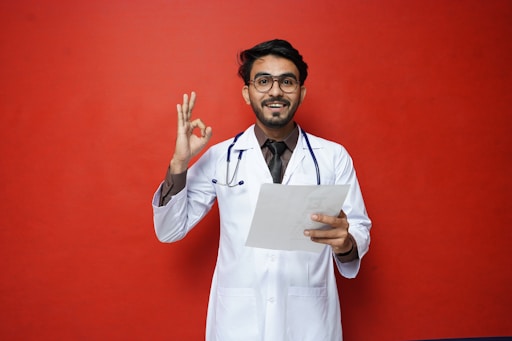 a man in a white coat holding a piece of paper