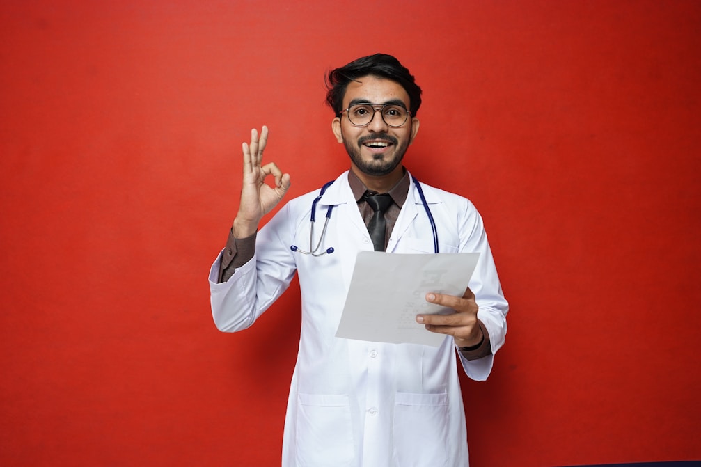 a man in a white coat holding a piece of paper