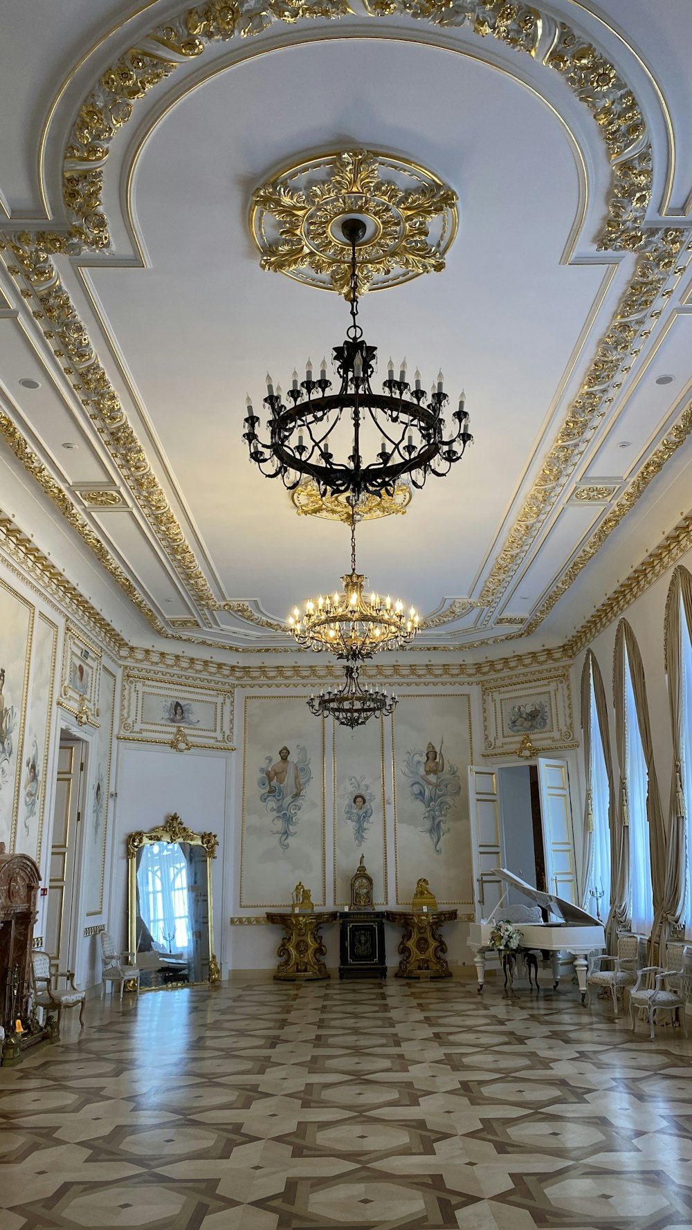 a large ornate room with a chandelier and a table