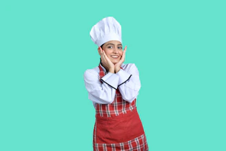 a person wearing a white hat and holding the hands up