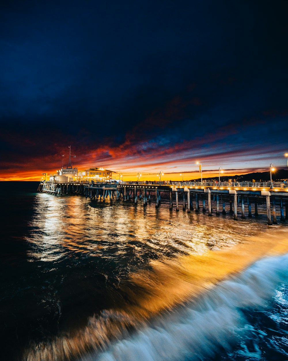 a dock with a sunset in the background