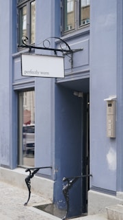 A welcoming entrance to a Perfect Home property with signature dark yellow-orange signage.