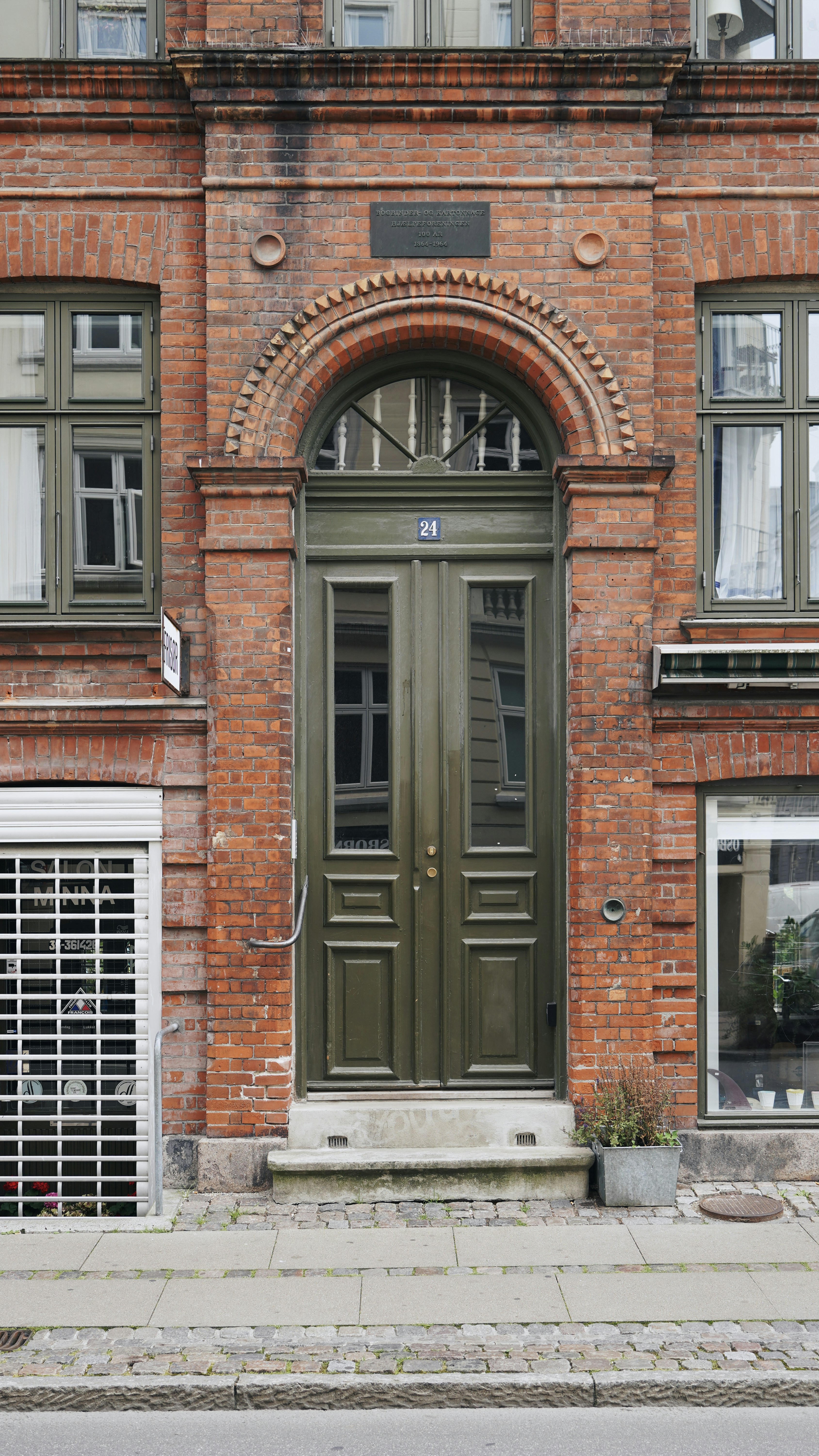 a brick building with a green door
