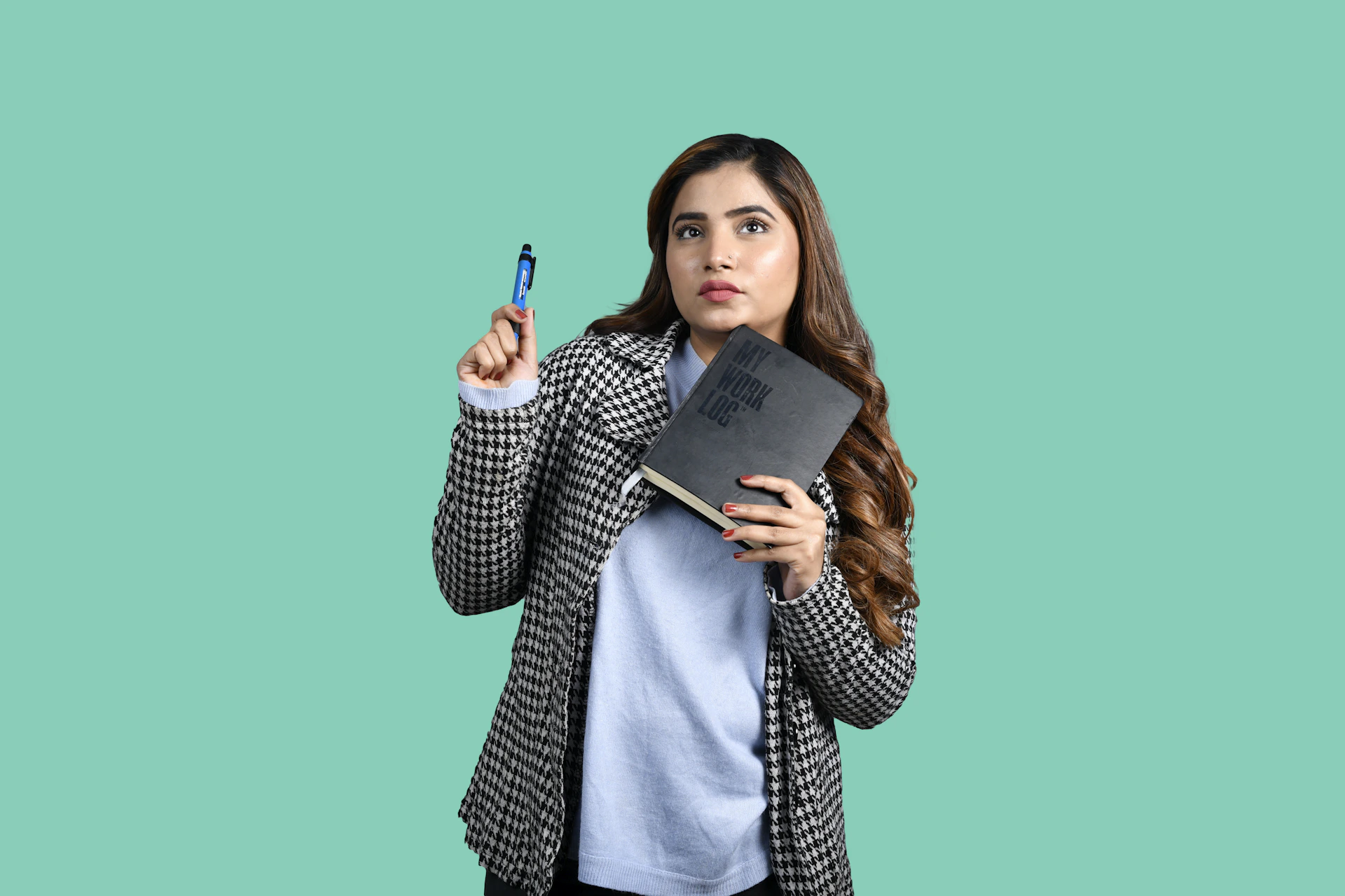 a person holding a pen and a book