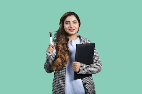 a woman holding a pen and a notebook