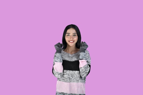 A young woman smiling confidently while wearing a soft, comfortable sweater from femme favs collection.