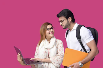 a man and woman looking at a laptop