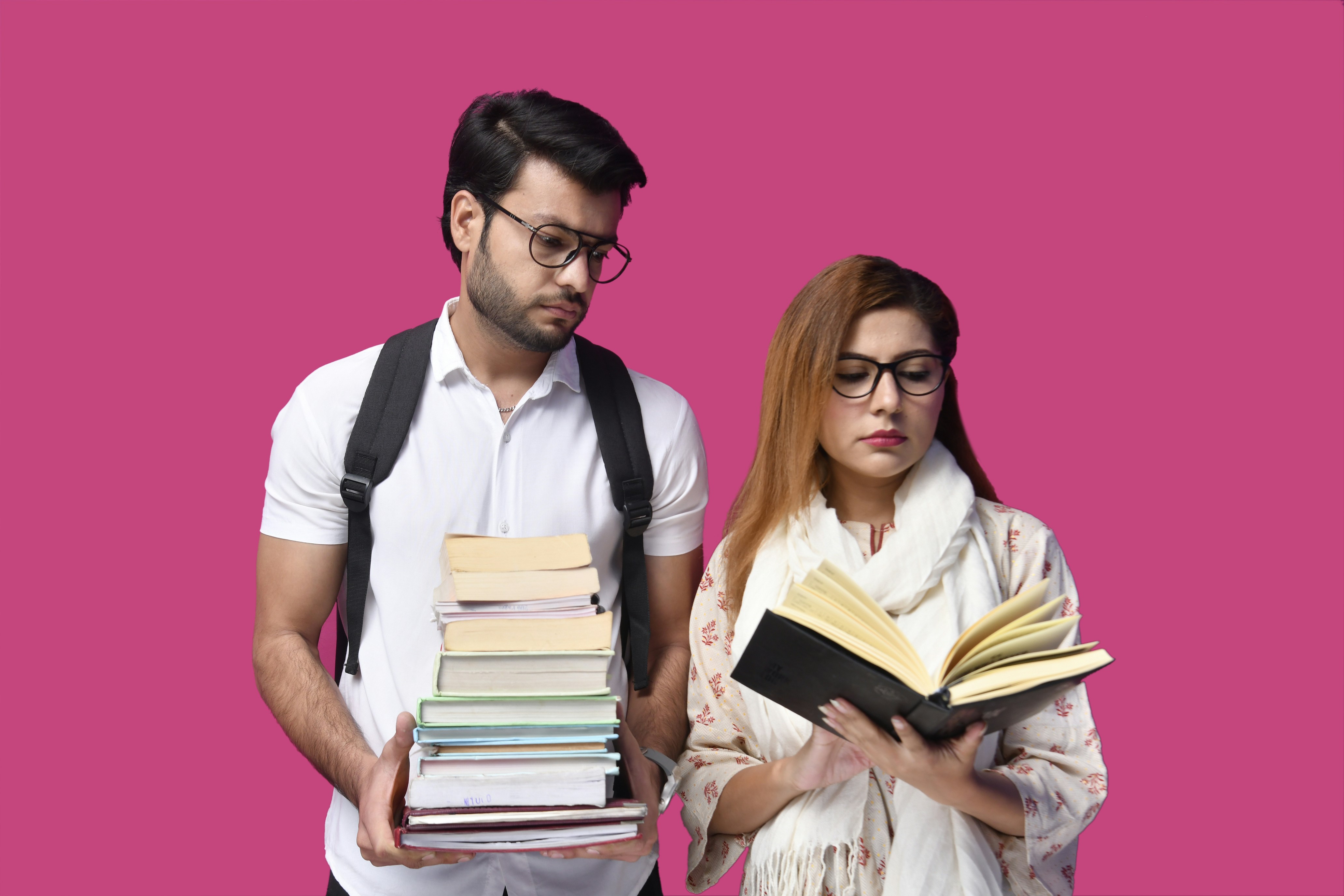 a man and a woman holding books