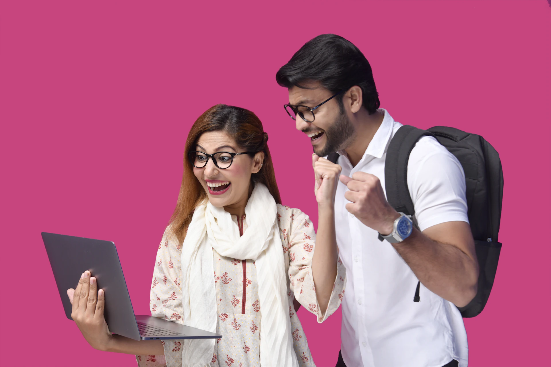a man and a woman looking at a laptop