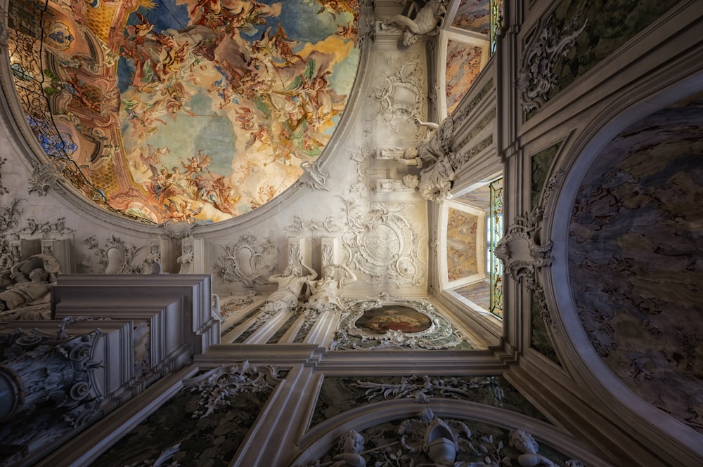 a room with a ceiling and paintings