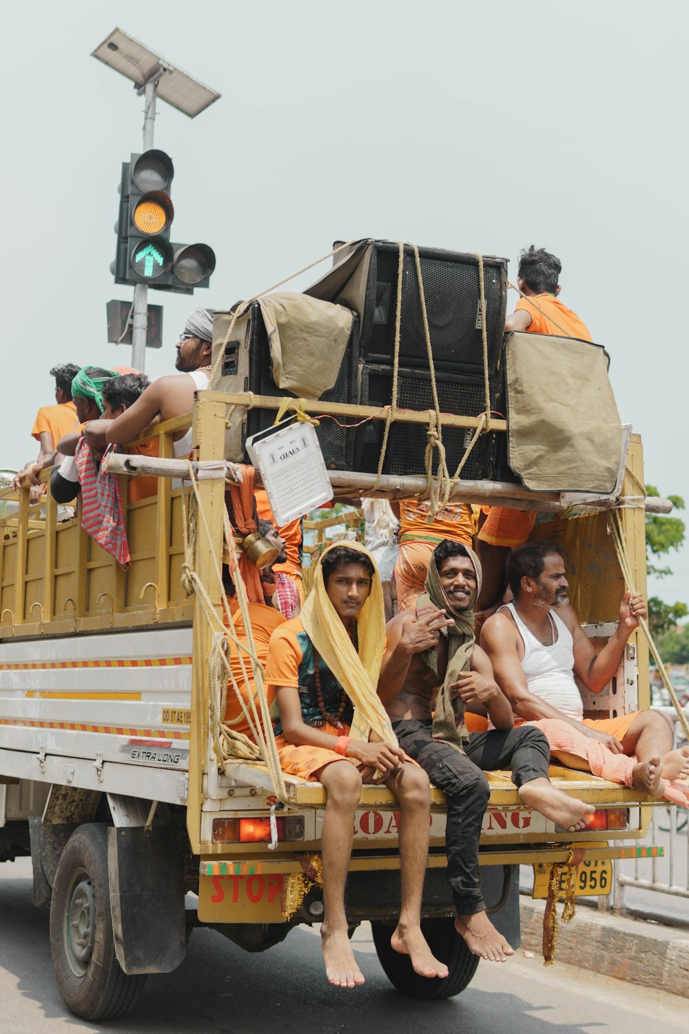 a group of people ride on a truck