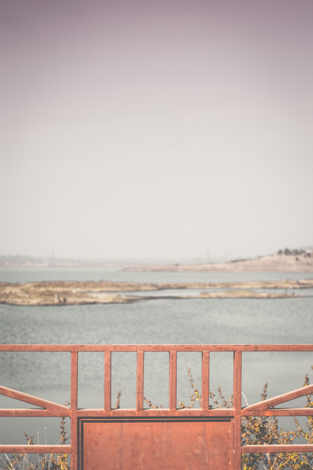 a red railing overlooking a body of water