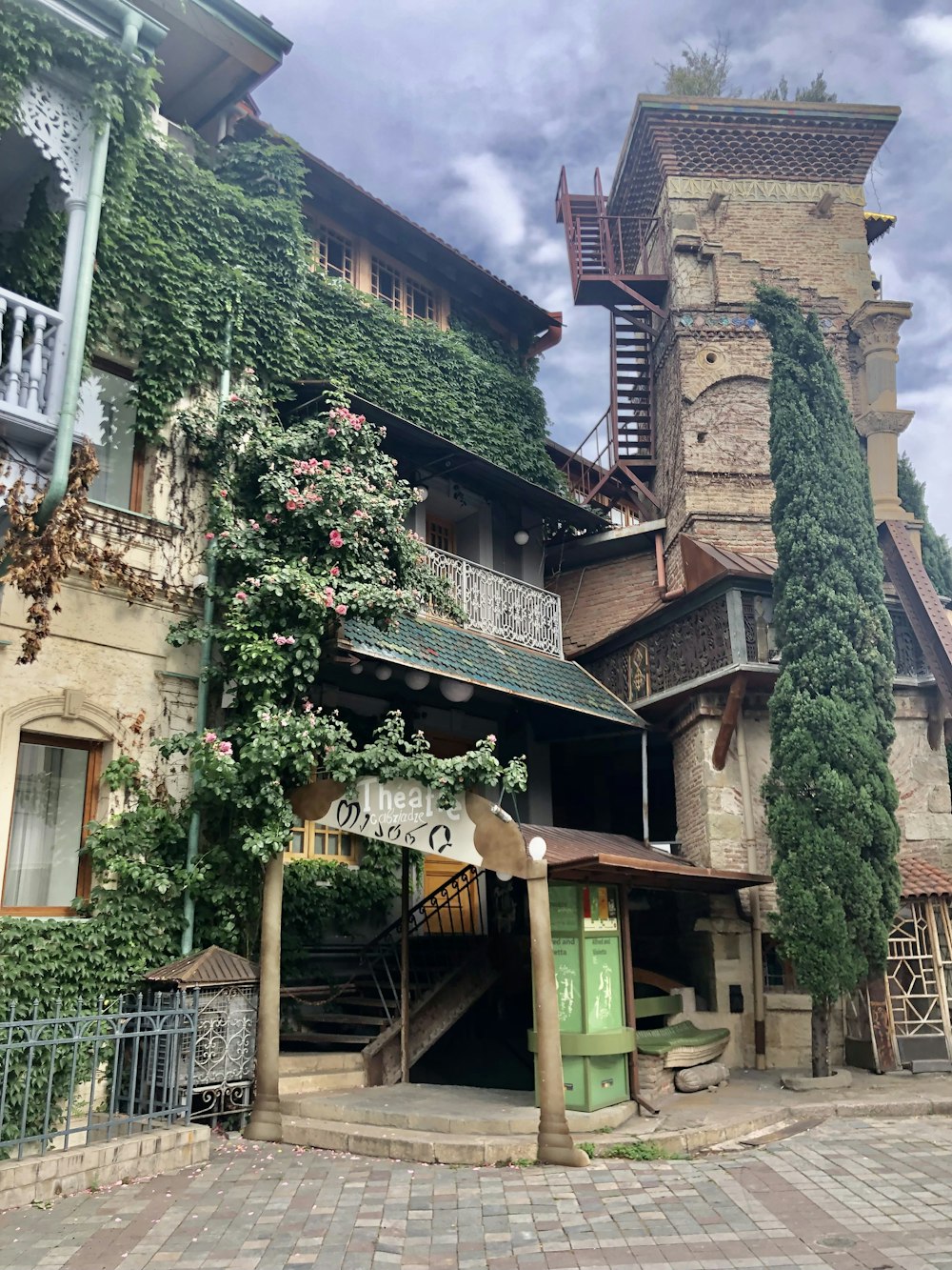 a building with a staircase and plants on the side