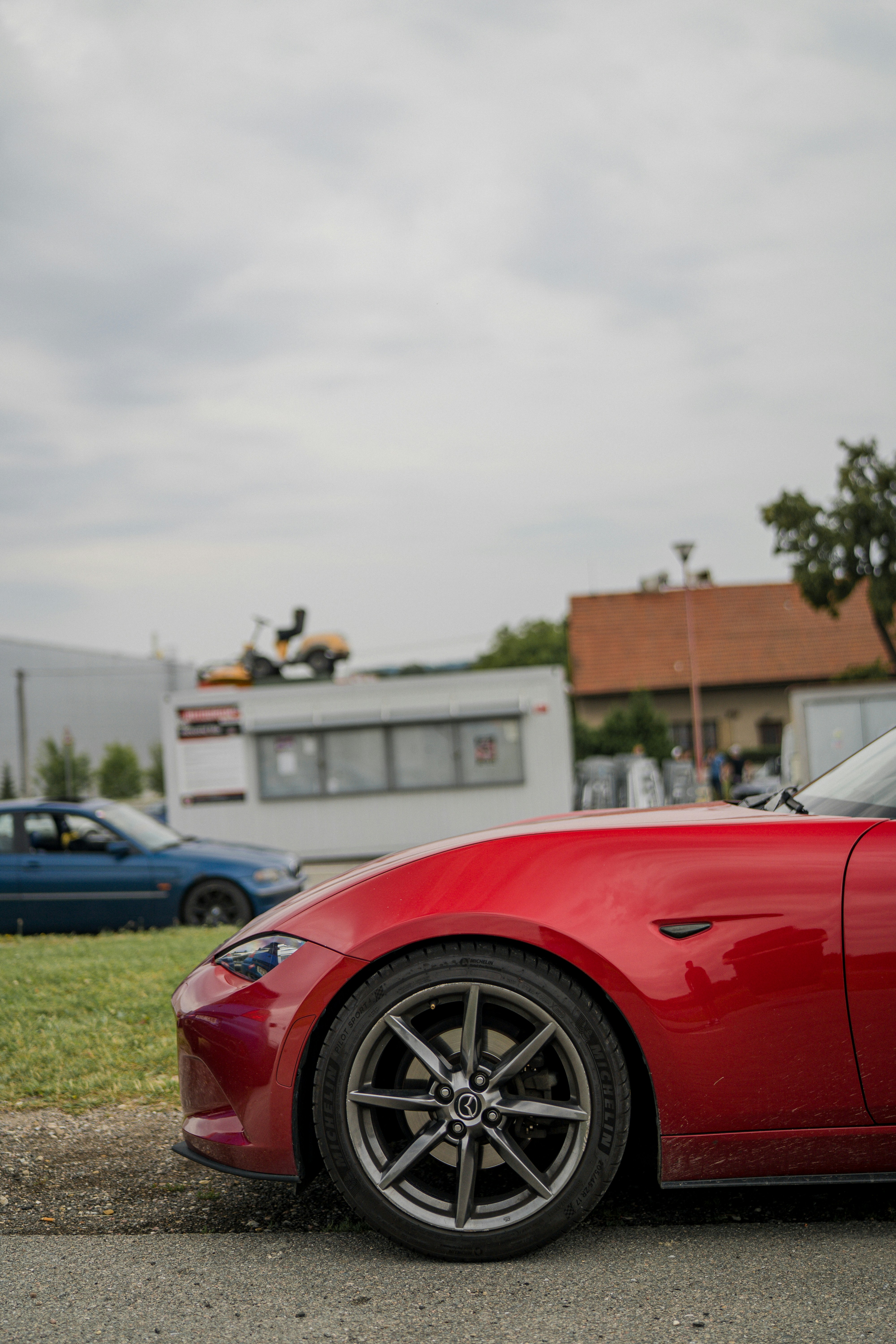 A red car parked in front of a building