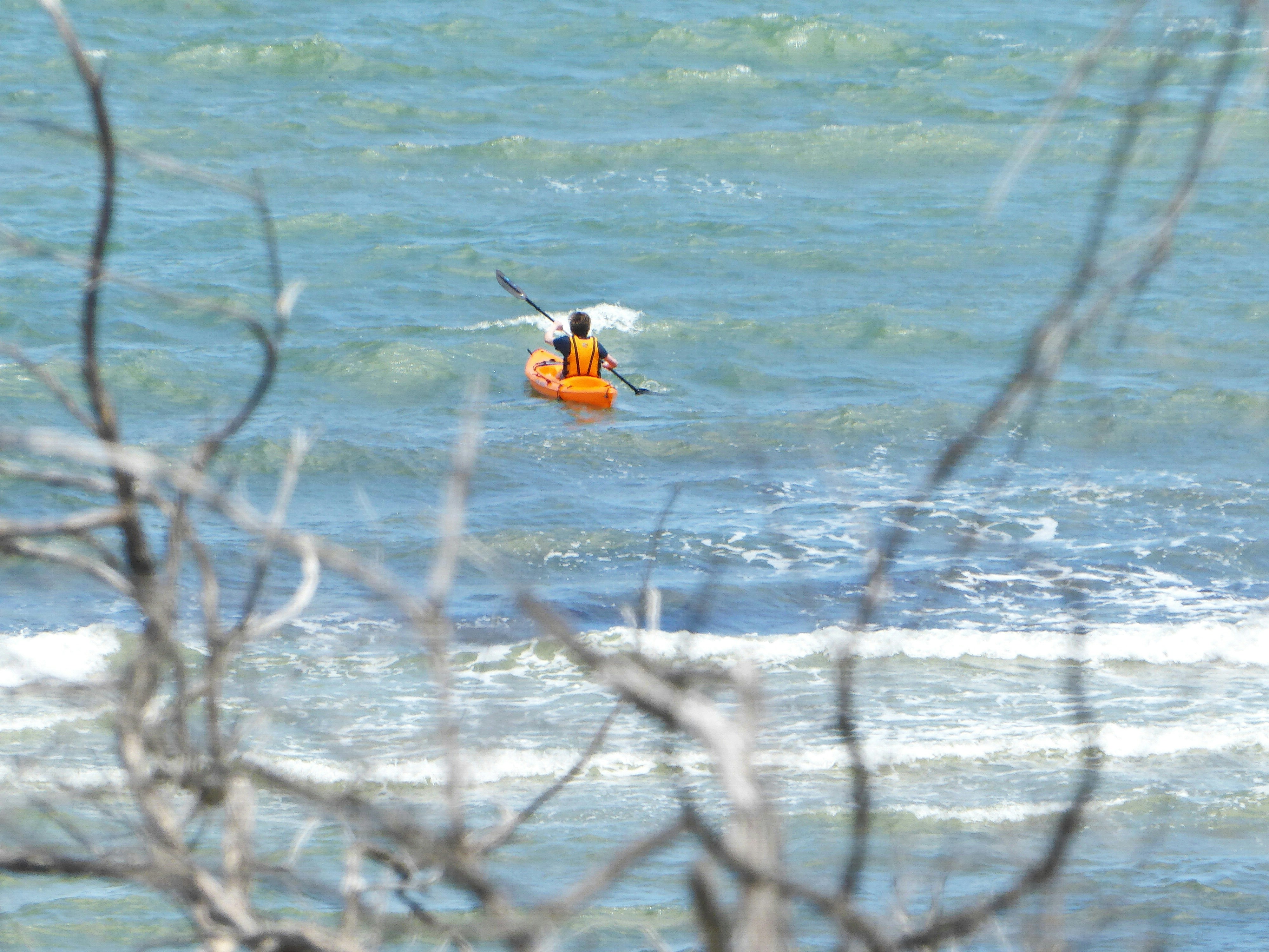 a person in a kayak in a lake