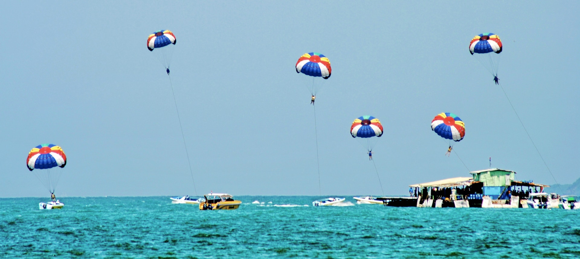 a group of people parasailing over the ocean