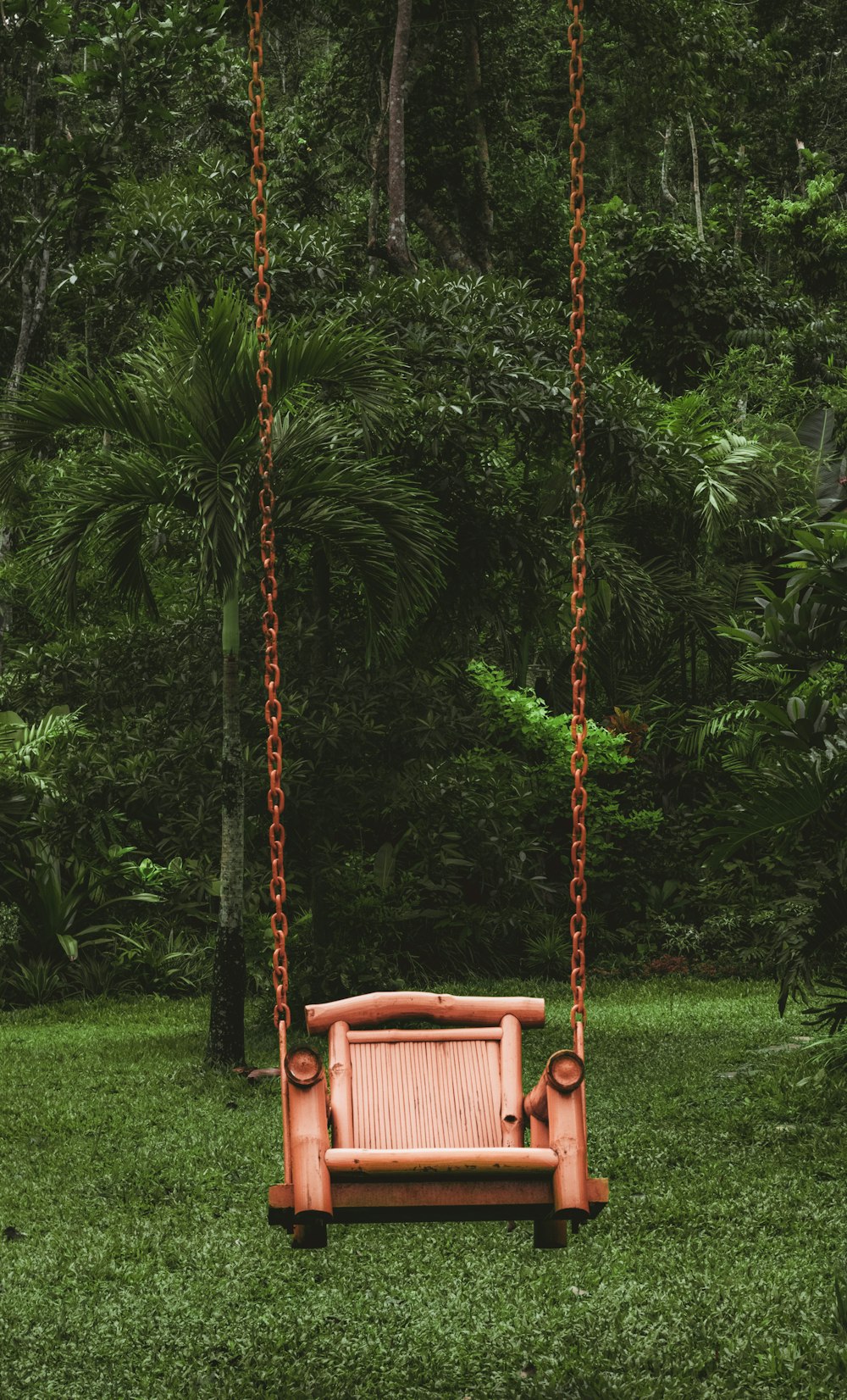 a wooden swing in a yard